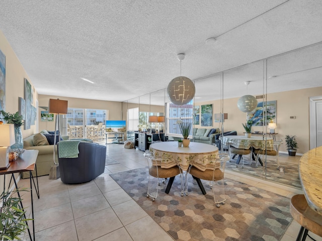 dining area with light tile patterned floors and a textured ceiling