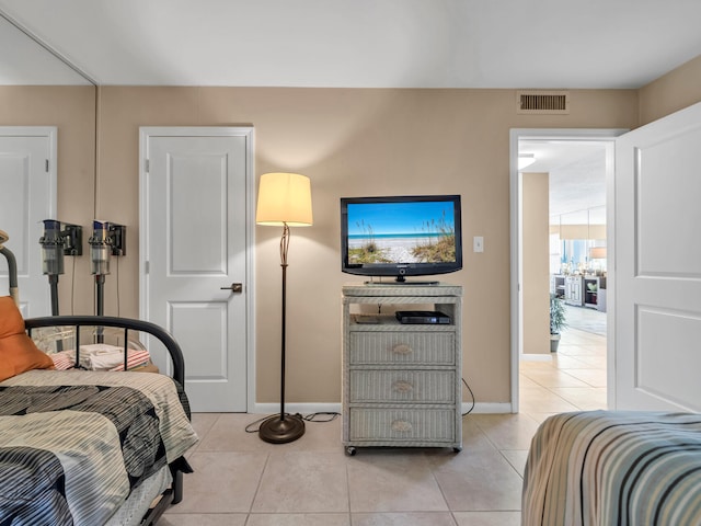 bedroom with light tile patterned floors