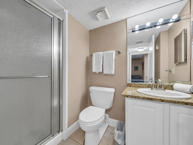 bathroom with a textured ceiling, tile patterned floors, a shower with door, vanity, and toilet