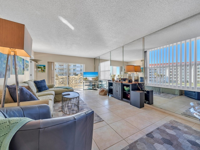 tiled living room featuring a textured ceiling