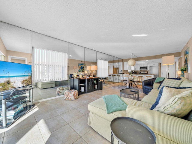 tiled living room featuring a textured ceiling