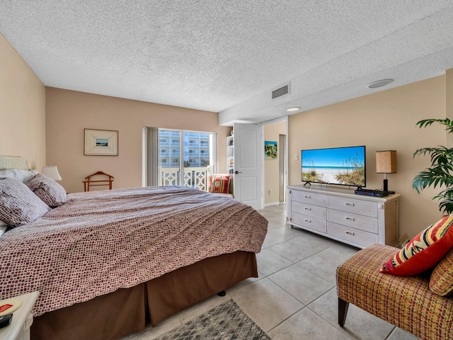 tiled bedroom with a textured ceiling