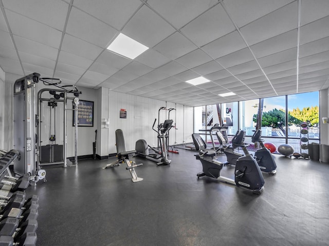 gym with a wall of windows