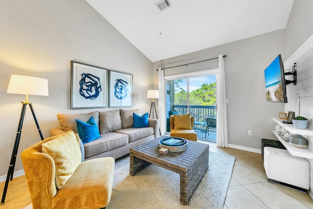 living room featuring light tile patterned floors and high vaulted ceiling