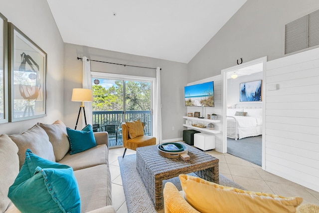 tiled living room featuring high vaulted ceiling