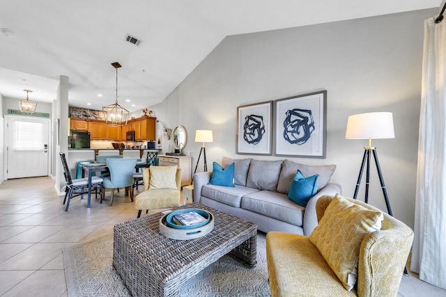 living room featuring light tile patterned floors, lofted ceiling, and a notable chandelier