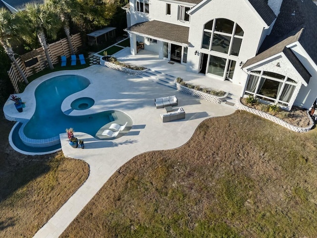 view of swimming pool featuring a patio area and a jacuzzi