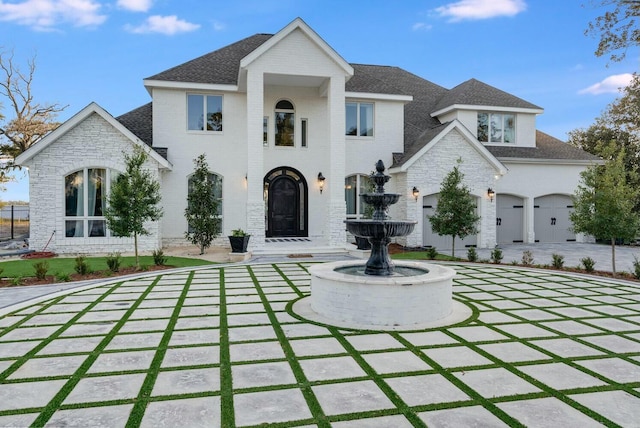 french country style house with a garage