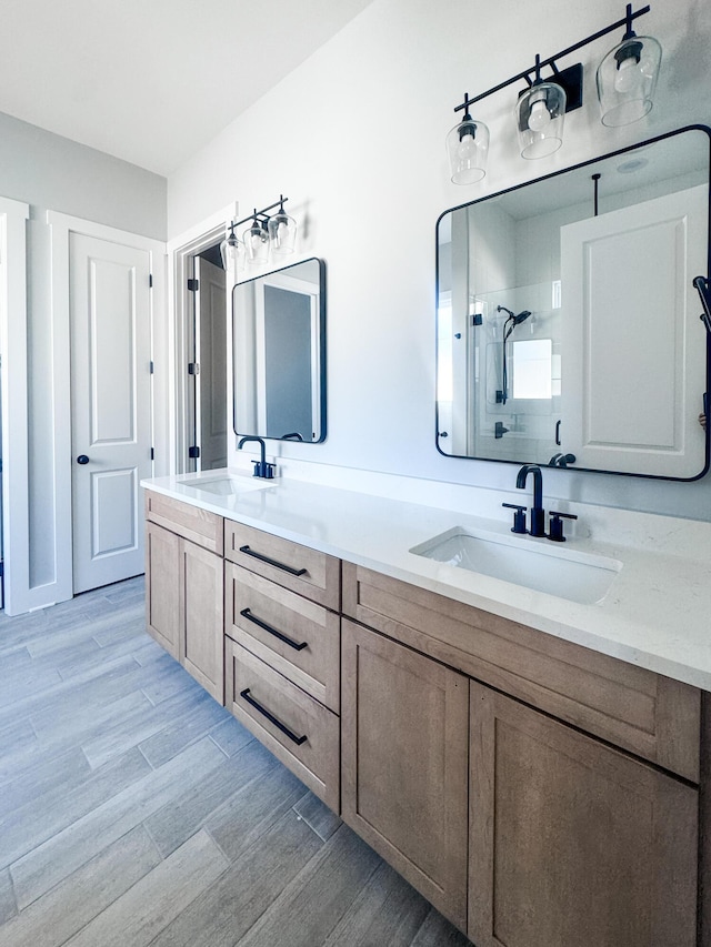 bathroom with vanity, wood-type flooring, and walk in shower