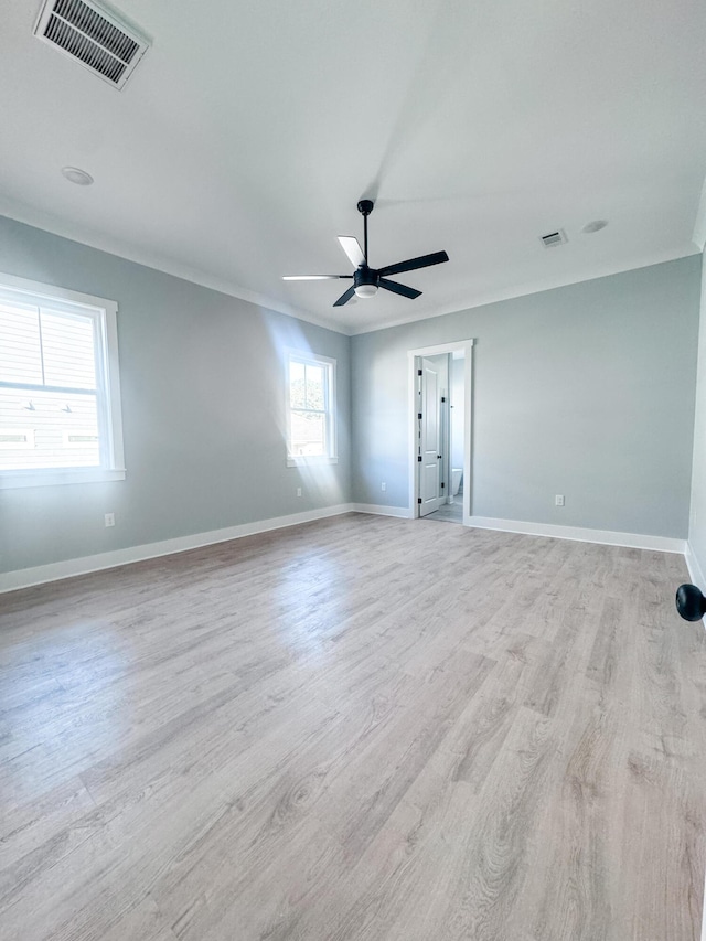 spare room featuring light hardwood / wood-style floors, plenty of natural light, and ceiling fan