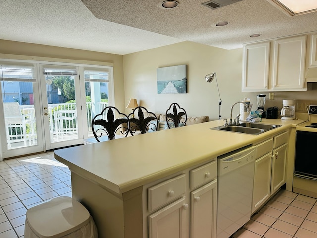 2830 Scenic Gulf Dr Unit 115, Miramar Beach, FL 32550 - kitchen featuring dishwasher, electric stove, light tile patterned flooring, light countertops, and a textured ceiling