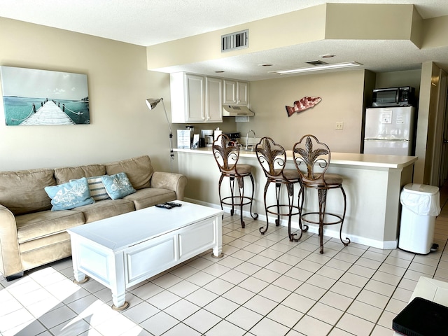 2830 Scenic Gulf Dr Unit 115, Miramar Beach, FL 32550 - living area featuring light tile patterned floors and a textured ceiling