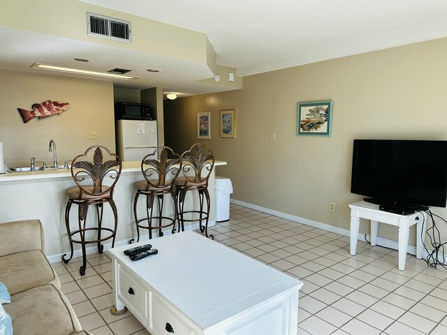 2830 Scenic Gulf Dr Unit 115, Miramar Beach, FL 32550 - living room with light tile patterned flooring and baseboards