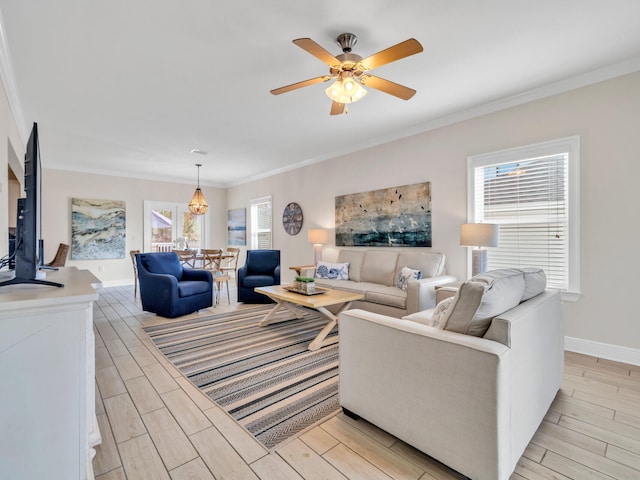 living room with light hardwood / wood-style flooring, ceiling fan, and crown molding