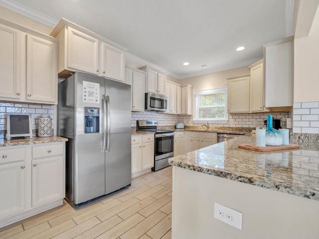 kitchen featuring decorative backsplash, light stone countertops, ornamental molding, and appliances with stainless steel finishes