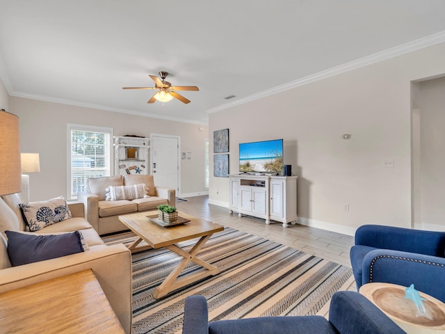 living room featuring ceiling fan, light wood-type flooring, and crown molding