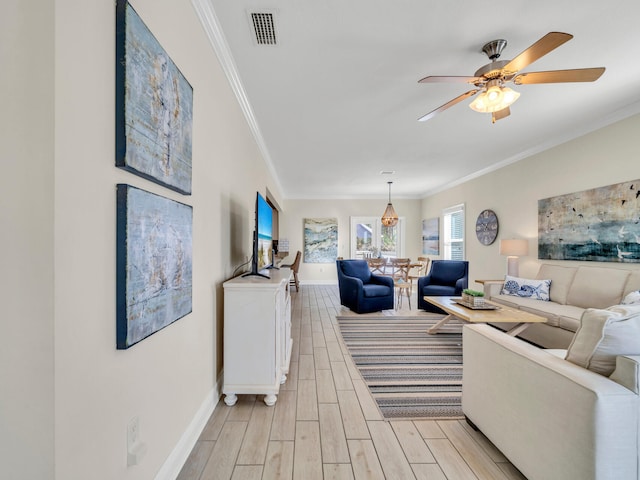 living room featuring light hardwood / wood-style flooring, ceiling fan, and ornamental molding