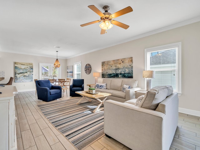 living room featuring light wood-type flooring, ceiling fan, and ornamental molding