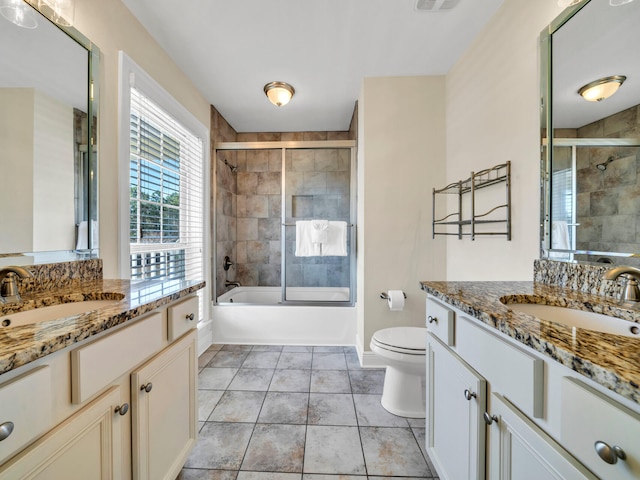 full bathroom featuring tile patterned flooring, vanity, toilet, and enclosed tub / shower combo