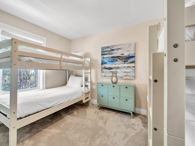 bedroom featuring multiple windows and light colored carpet