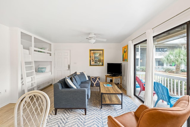 living room featuring light wood-type flooring and ceiling fan