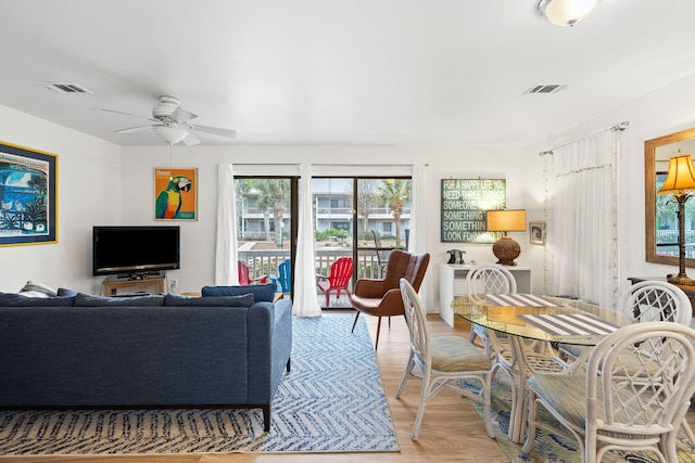 living room with ceiling fan and light hardwood / wood-style floors