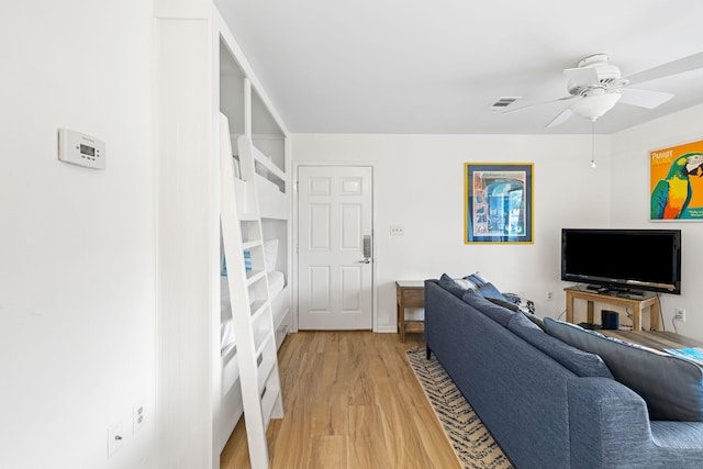 living room featuring hardwood / wood-style flooring and ceiling fan