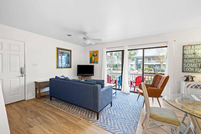 living room featuring ceiling fan and light wood-type flooring