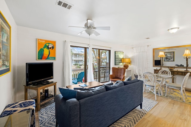 living room with ceiling fan and light wood-type flooring