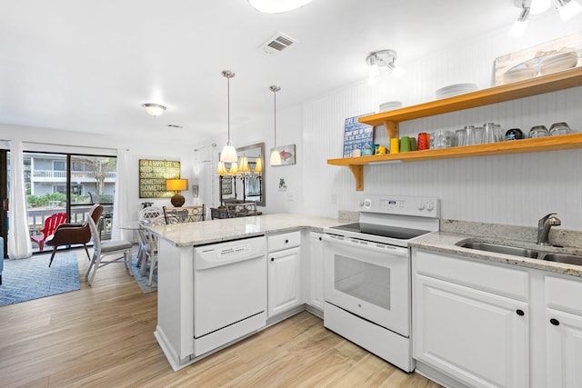3799 E County Highway 30a # E-6, Santa Rosa Beach, FL 32459 - kitchen featuring white appliances, a peninsula, light wood-style flooring, and white cabinets