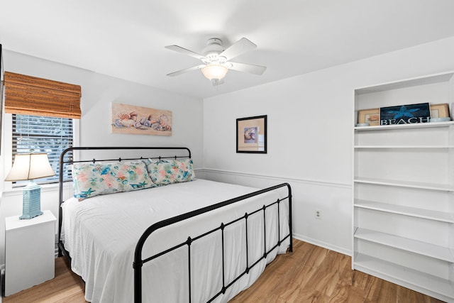 bedroom with ceiling fan and light wood-type flooring