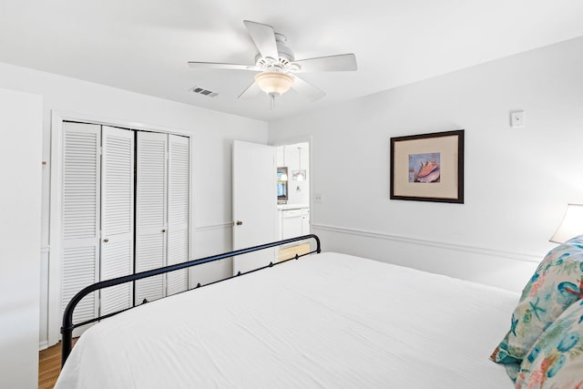 bedroom featuring hardwood / wood-style flooring, ceiling fan, and a closet