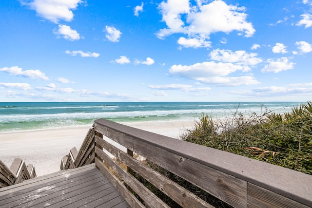 view of property's community with a water view and a view of the beach