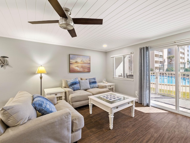 living room featuring wood ceiling, ceiling fan, crown molding, and dark wood-type flooring