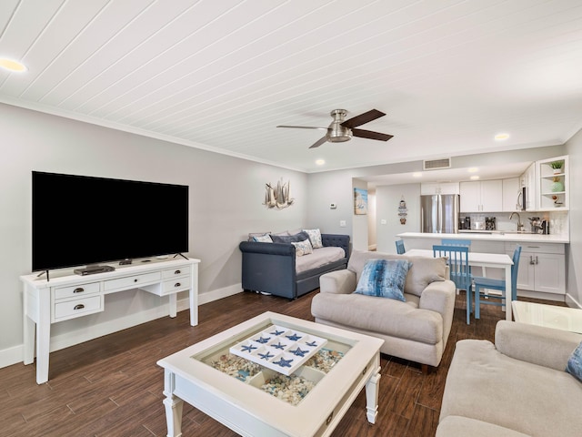 living room with ceiling fan, sink, crown molding, and dark hardwood / wood-style floors