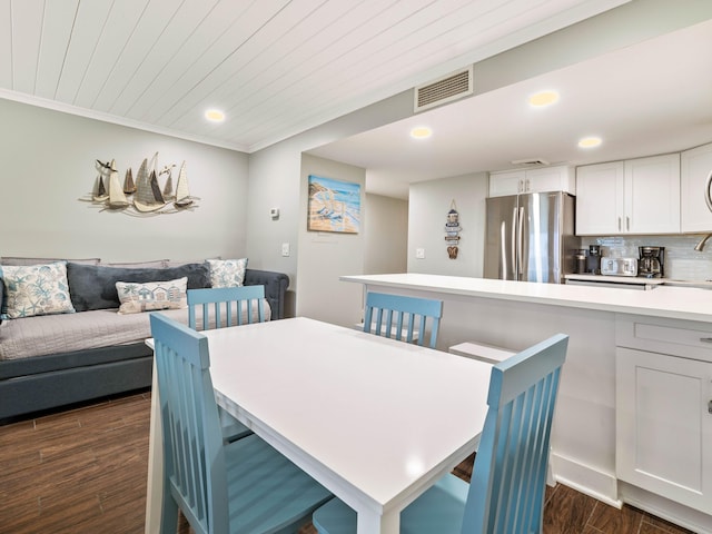 dining space featuring wooden ceiling, dark hardwood / wood-style floors, crown molding, and sink