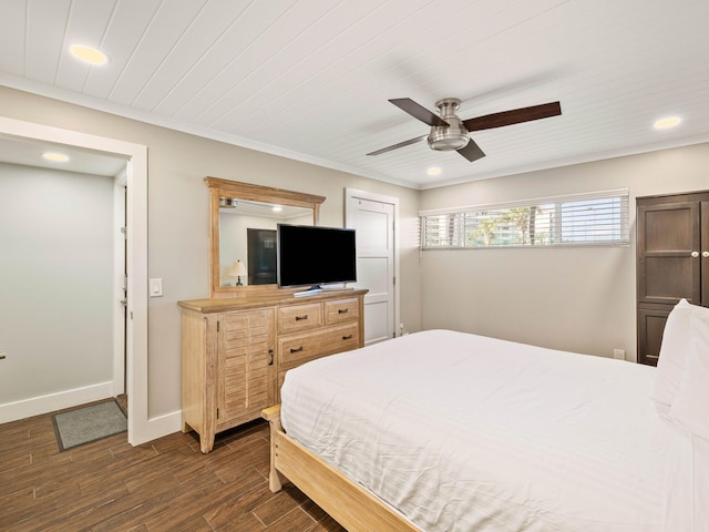 bedroom featuring ceiling fan, crown molding, and dark wood-type flooring