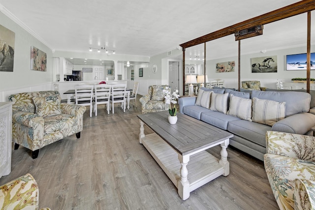 living room featuring crown molding and wood-type flooring