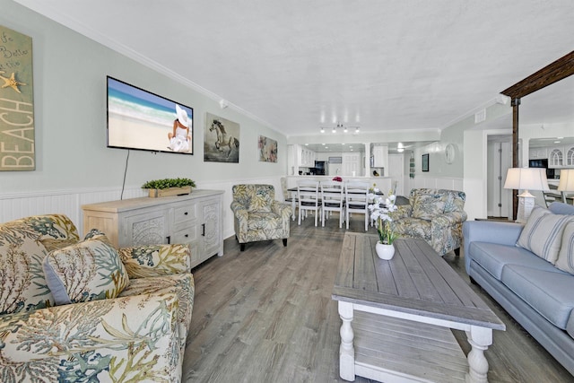 living room with light wood-type flooring and ornamental molding