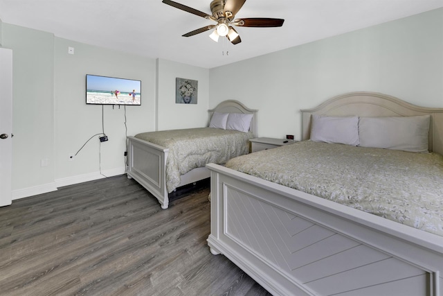 bedroom with ceiling fan and dark hardwood / wood-style flooring