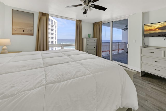 bedroom with ceiling fan, expansive windows, access to exterior, and wood-type flooring