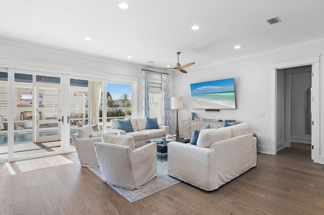 living room with crown molding, ceiling fan, and hardwood / wood-style flooring