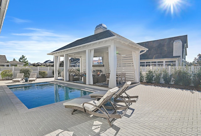 view of pool featuring a gazebo, a patio area, and an outdoor living space