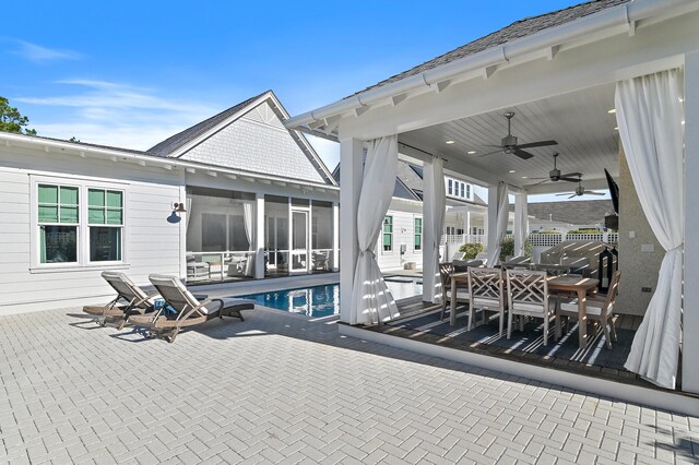 exterior space with ceiling fan and a sunroom