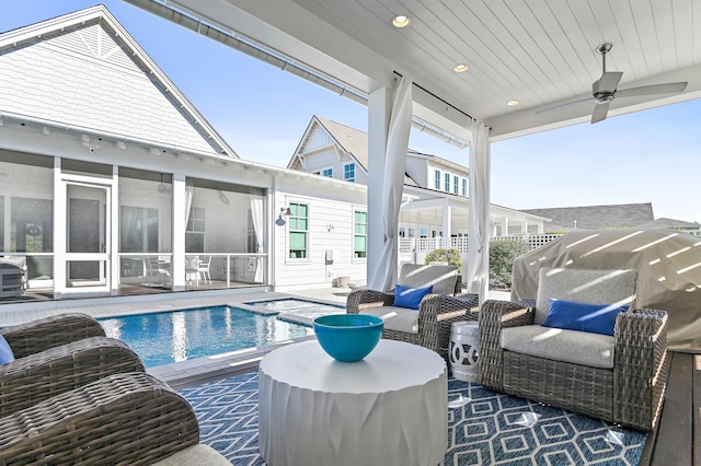 view of pool with an outdoor living space, a patio, ceiling fan, and a sunroom