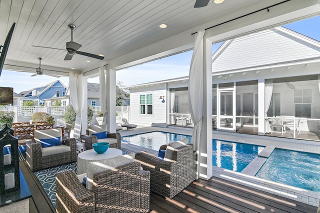 view of swimming pool featuring a sunroom, ceiling fan, and an outdoor hangout area