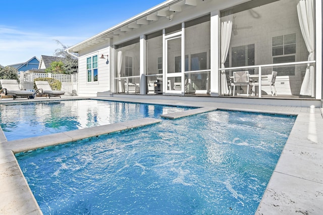 view of pool with a sunroom and a jacuzzi