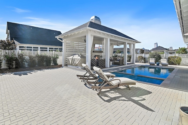 1016 Pathways Dr, Inlet Beach, FL 32461 - view of pool featuring a gazebo, a fenced backyard, a patio, and a warm lit fireplace