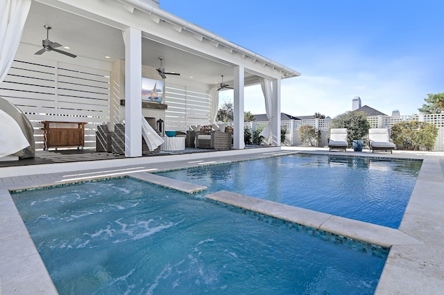 view of swimming pool featuring outdoor lounge area, ceiling fan, and a patio area