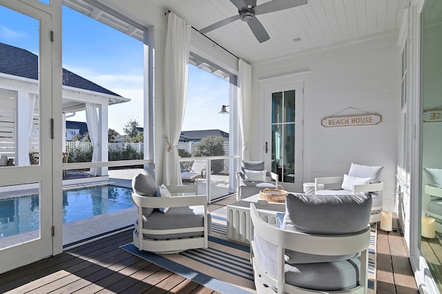 sunroom featuring ceiling fan